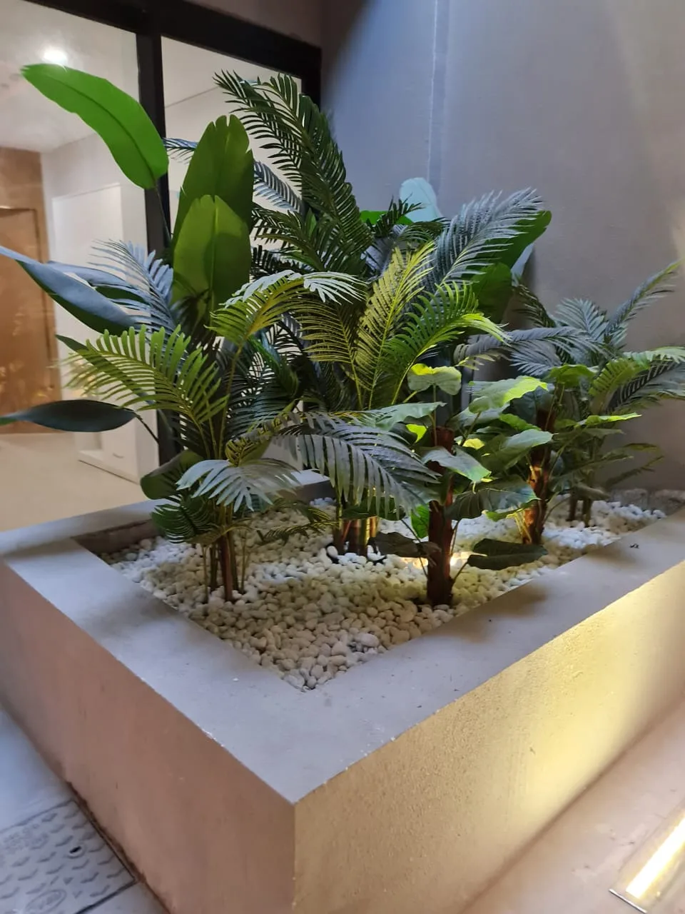 Real completed project: raised corner planter with palms in a commercial lobby