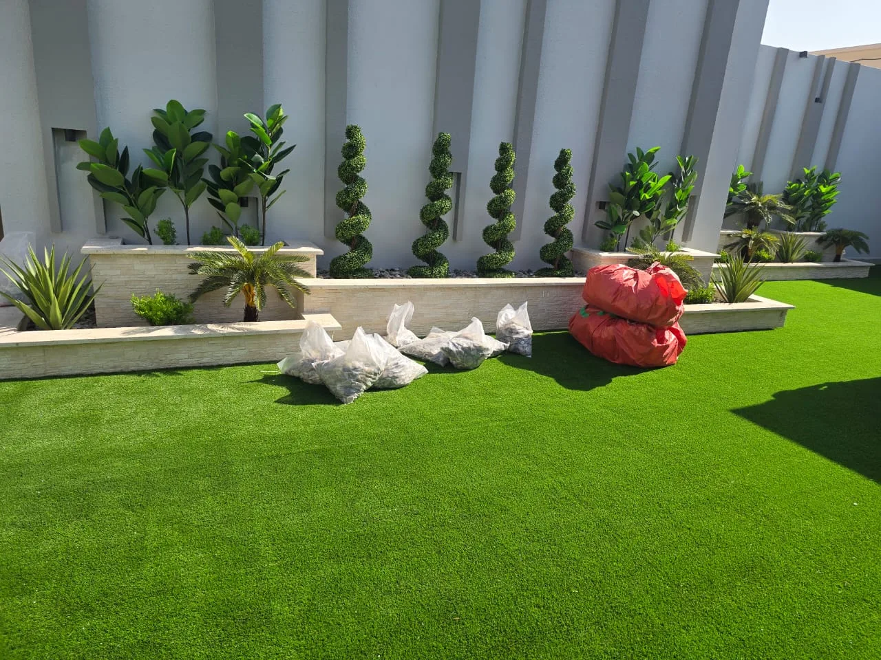 Real completed project: Grass laid and topiary planters in place, before final clean-up.