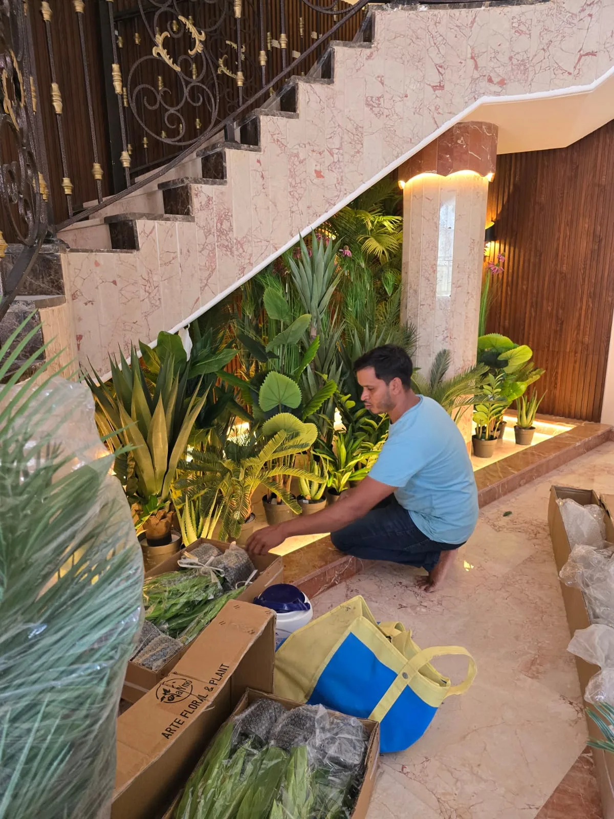 Real completed project: Our team arranging the potted greenery during installation.